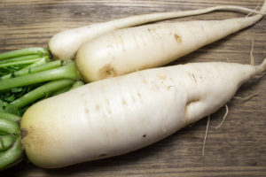 Daikon radish on the wood background