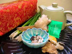 Teapot and selection of fresh and processed herbs