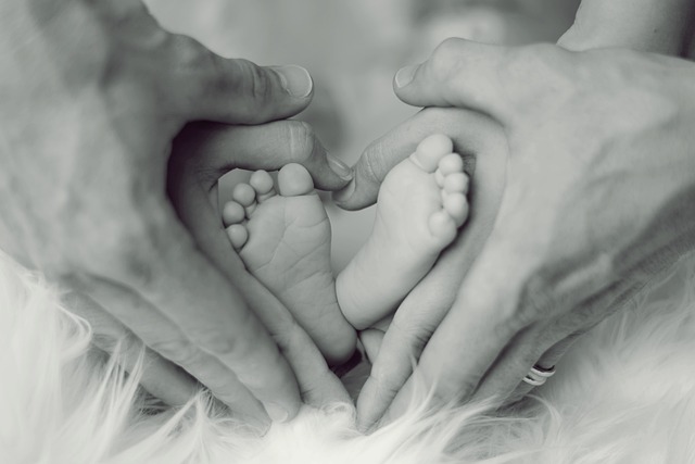 Hands surrounding baby feet